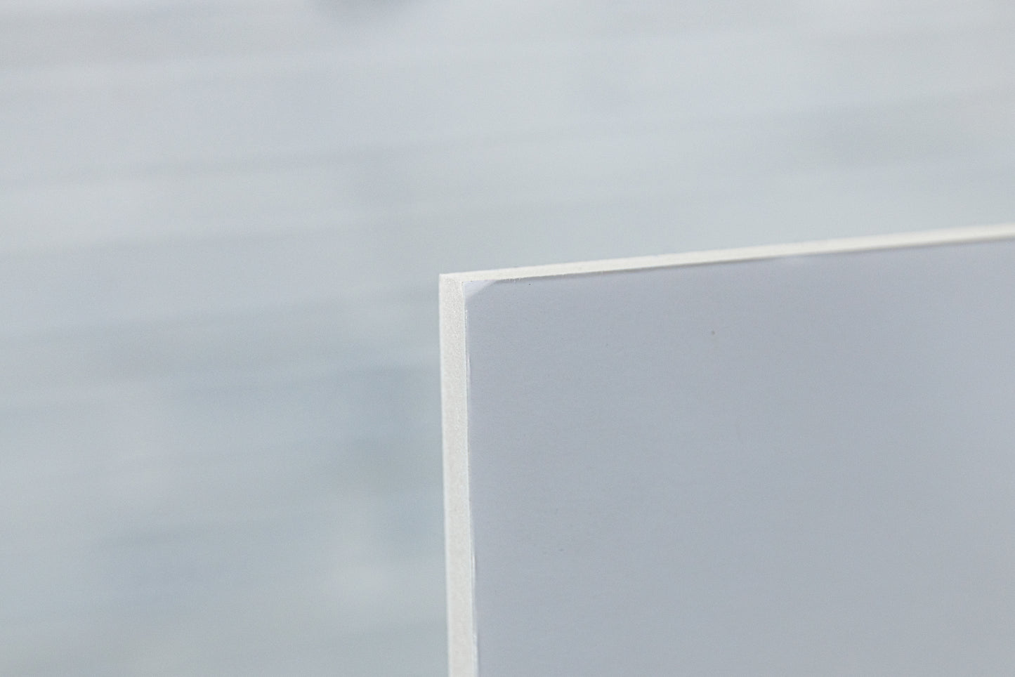 Close-up of rear foamboard corner showing a small scuff on the ex-display metallic photo print.