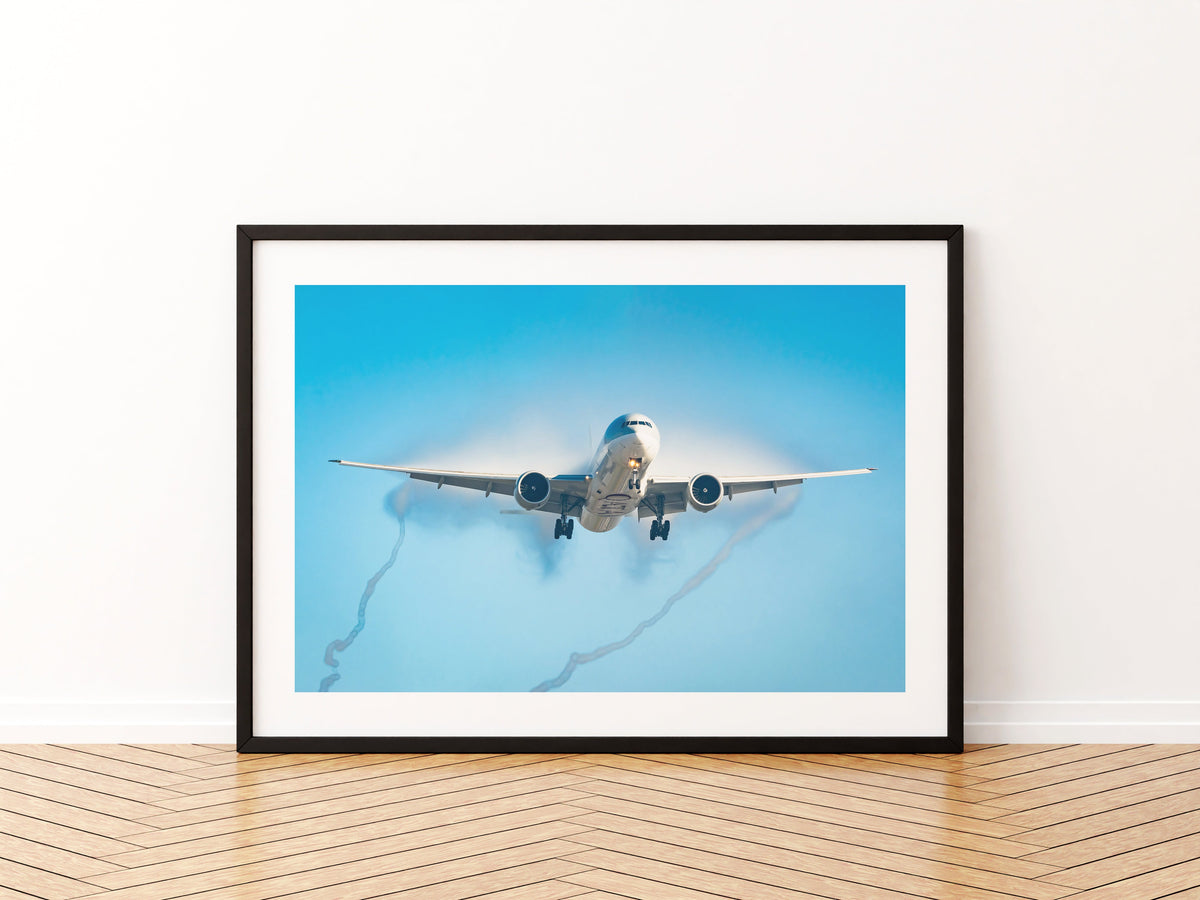 Qatar Airways Boeing 777 on approach in mist, twisting wingtip vortices trailing behind, aviation photo wall art print in a black frame