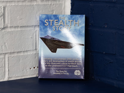 Front-on view of The Stealth Story box set against blue wall.