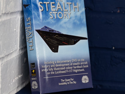 Front-on view of The Stealth Story box set against blue wall.