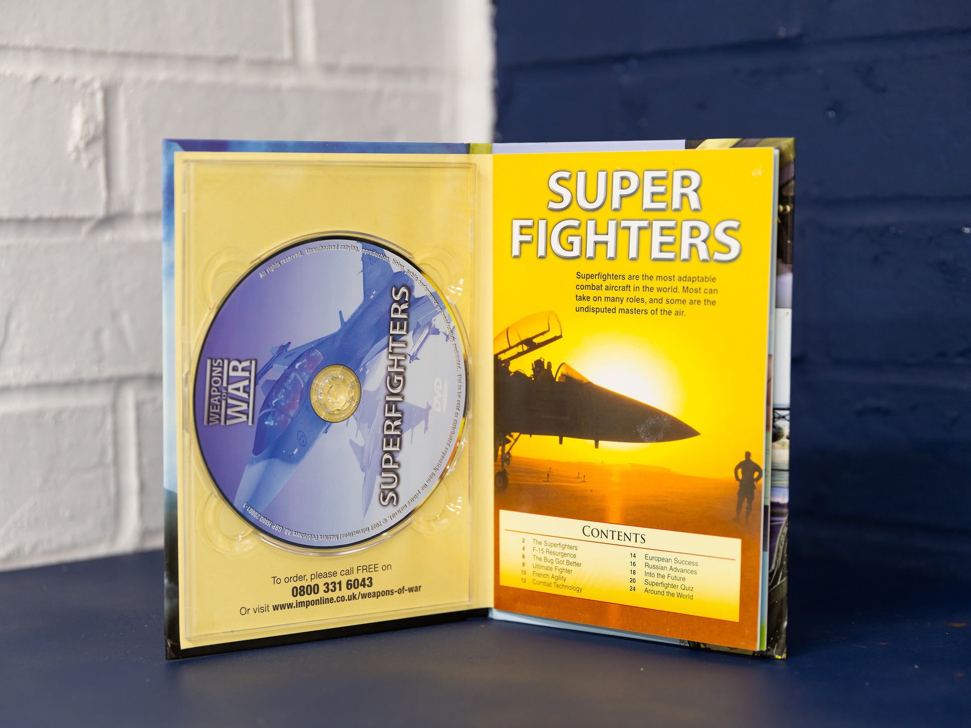 Inside view of Super Fighters case showing DVD and yellow booklet contents page.