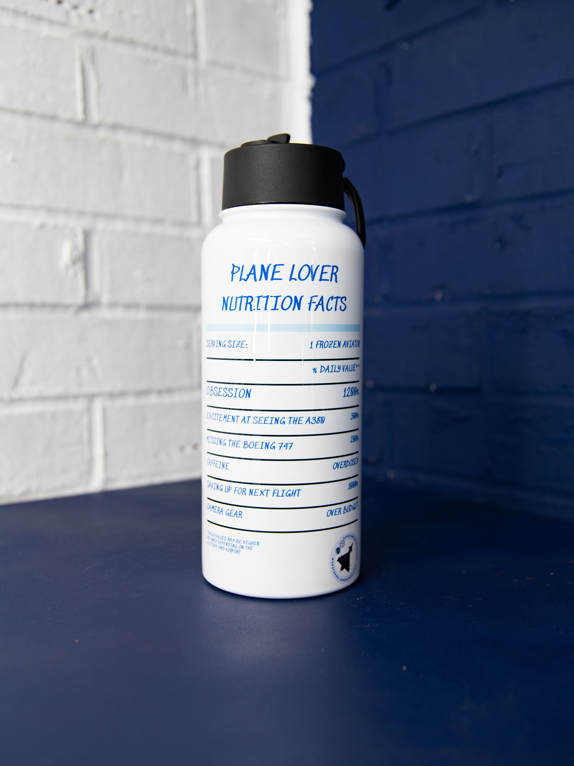 Rear three-quarter view with full “Plane Lover Nutrition Facts” graphic on glossy white body.