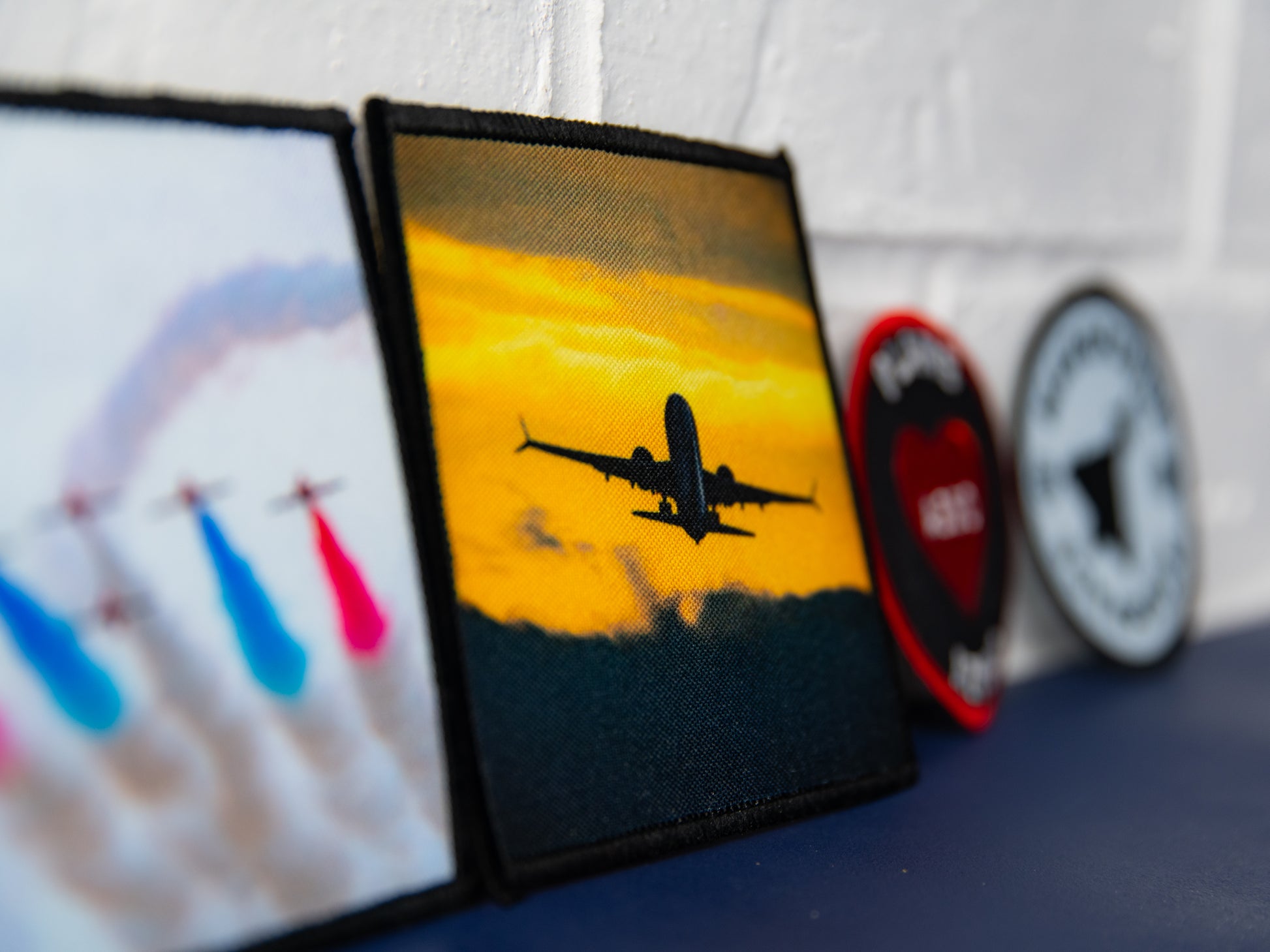Angled close-up of sunset airliner photo art square patch.