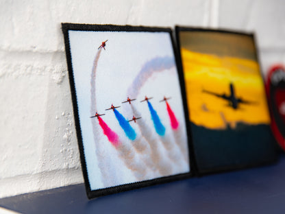 Angled close-up of Red Arrows photo art square patch with red, white, and blue smoke.