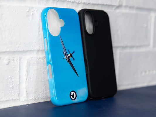 Front three-quarter view of blue Spitfire iPhone 16 tough case next to a plain black insert case.