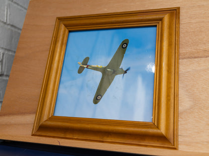 Front view of framed print showing the aircraft in flight against blue sky.