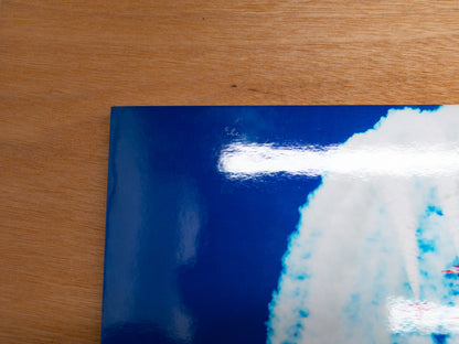 Corner close-up showing minor surface scuffs on the metallic paper.