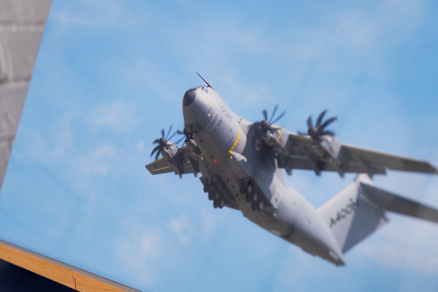 Close-up of Airbus A400M with spinning propellers on glossy photo paper paper