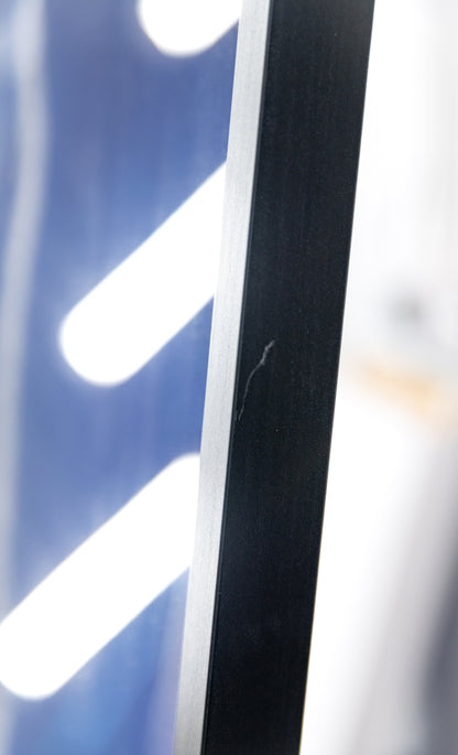 Detail of a light surface scratch on the black side rail of the frame