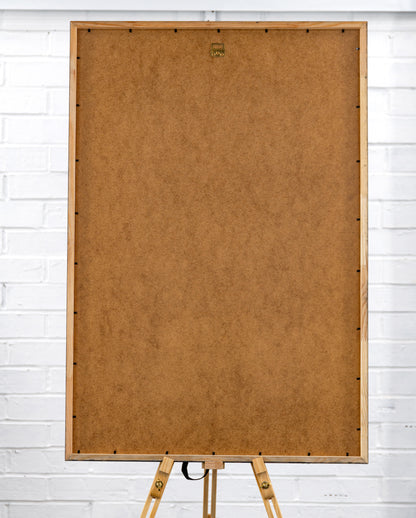 Rear view of the large framed poster showing brown MDF backing and a central sawtooth hanging bracket.