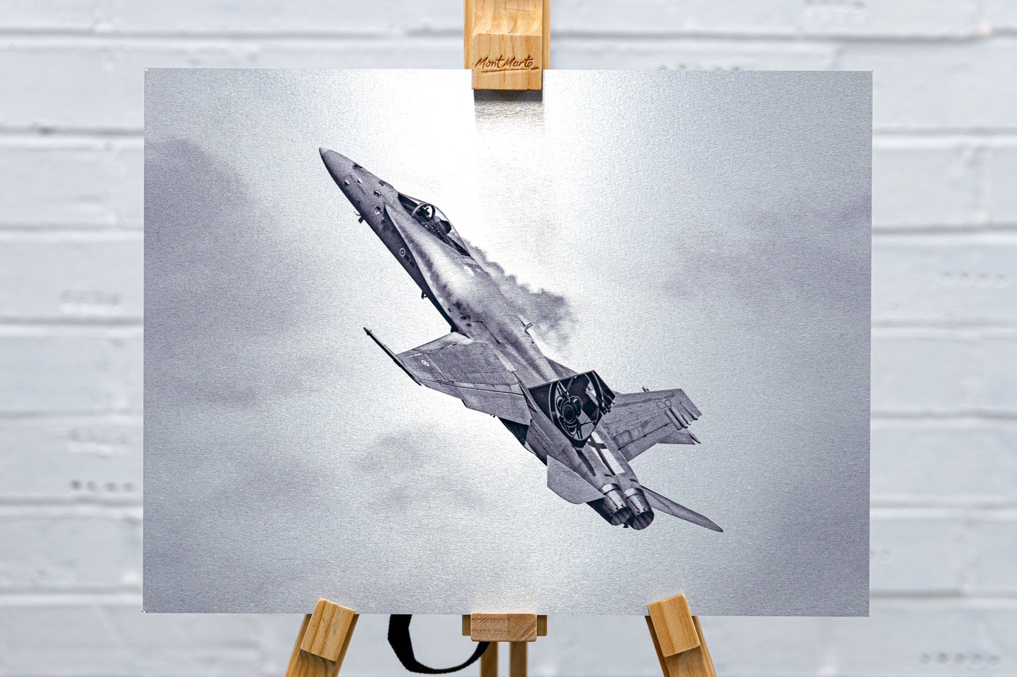 Straight-on, full-frame view of the Finnish F/A-18 Hornet brushed aluminium print on an easel.