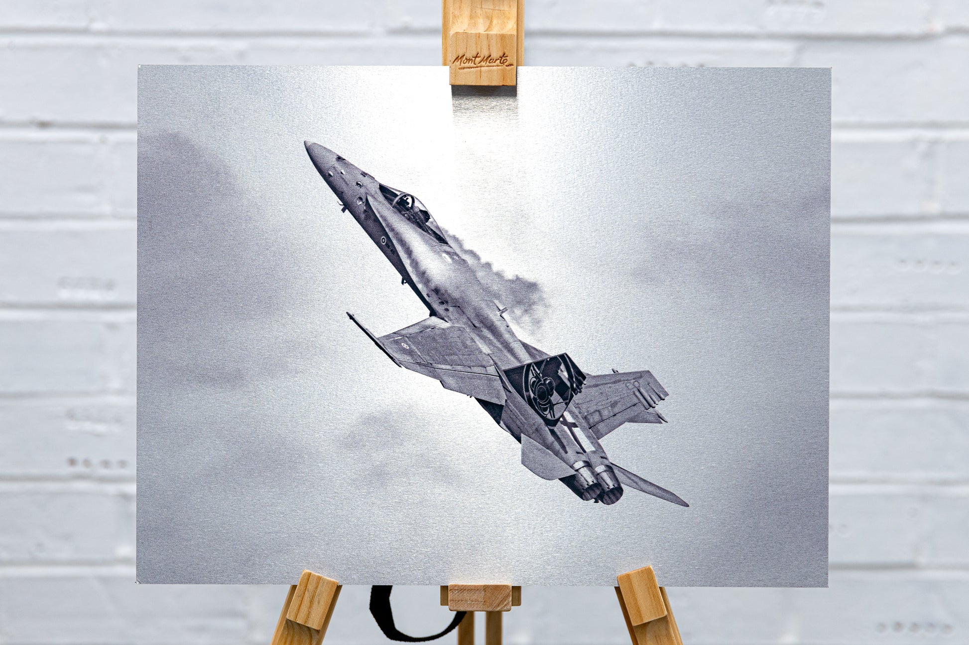 Straight-on, full-frame view of the Finnish F/A-18 Hornet brushed aluminium print on an easel.