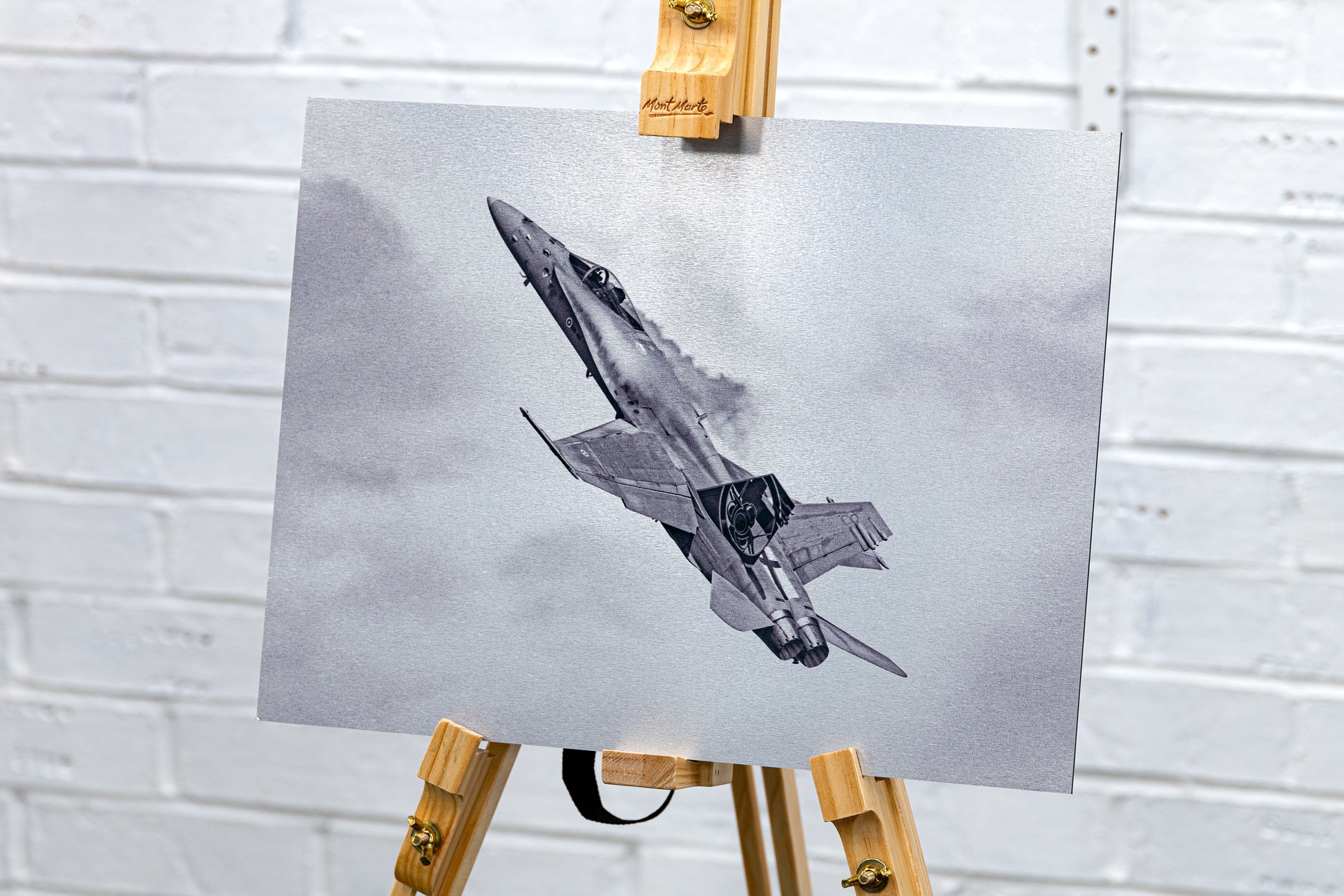 Wide studio view of the brushed aluminium Hornet print displayed on a wooden easel.