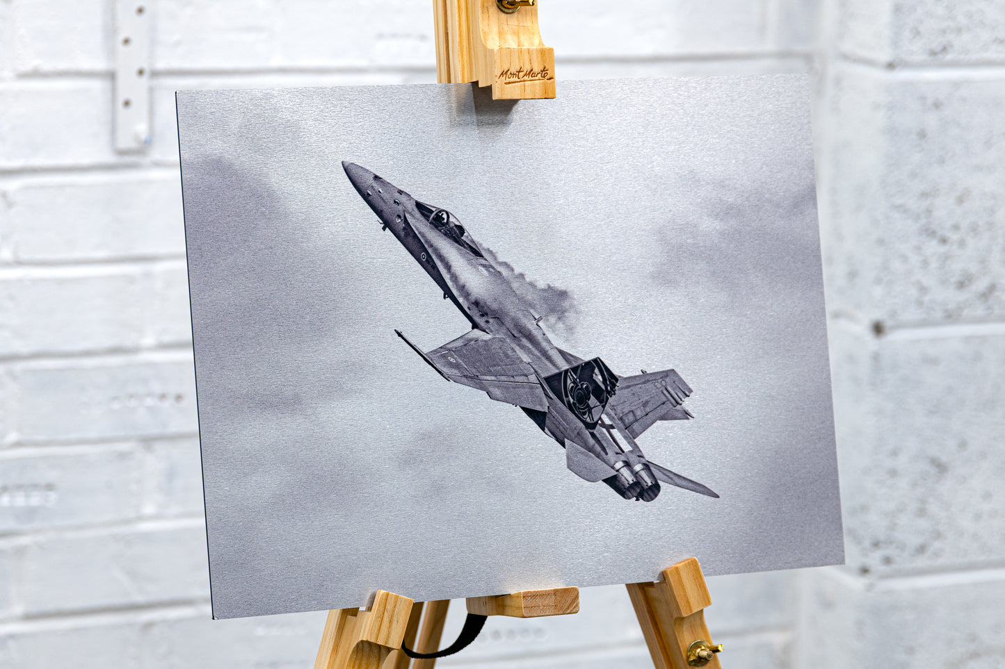 Three-quarter view on an easel of the Hornet brushed aluminium print, showing metallic texture and edge