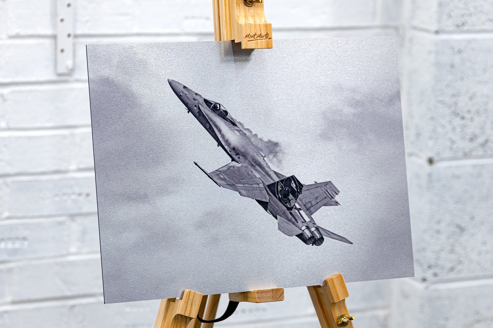 Three-quarter view on an easel of the Hornet brushed aluminium print, showing metallic texture and edge