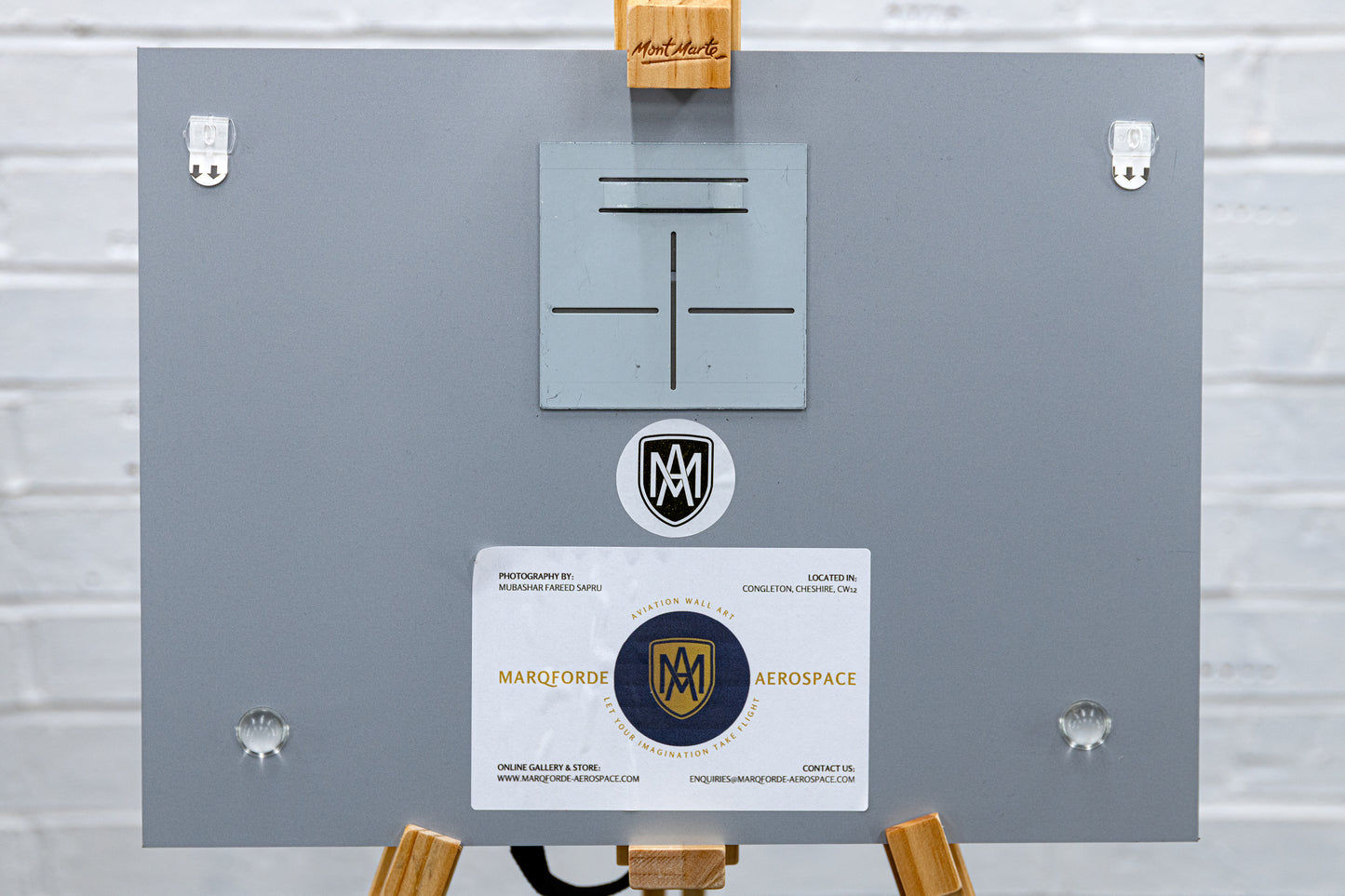 Back of the brushed aluminium print with float-mount plate, rubber bumpers and maker label.