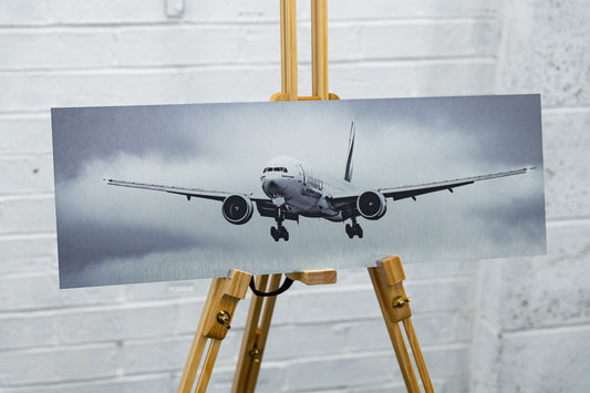 Three-quarter view of the aircraft on approach across the aluminium panel, highlighting texture and contrast.