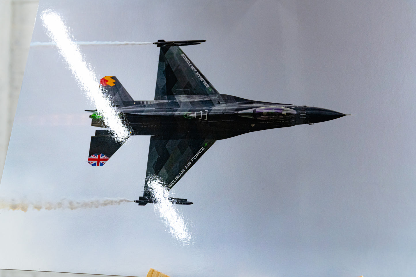 Angled front view of the mounted print showing the F-16 against a grey RIAT sky.