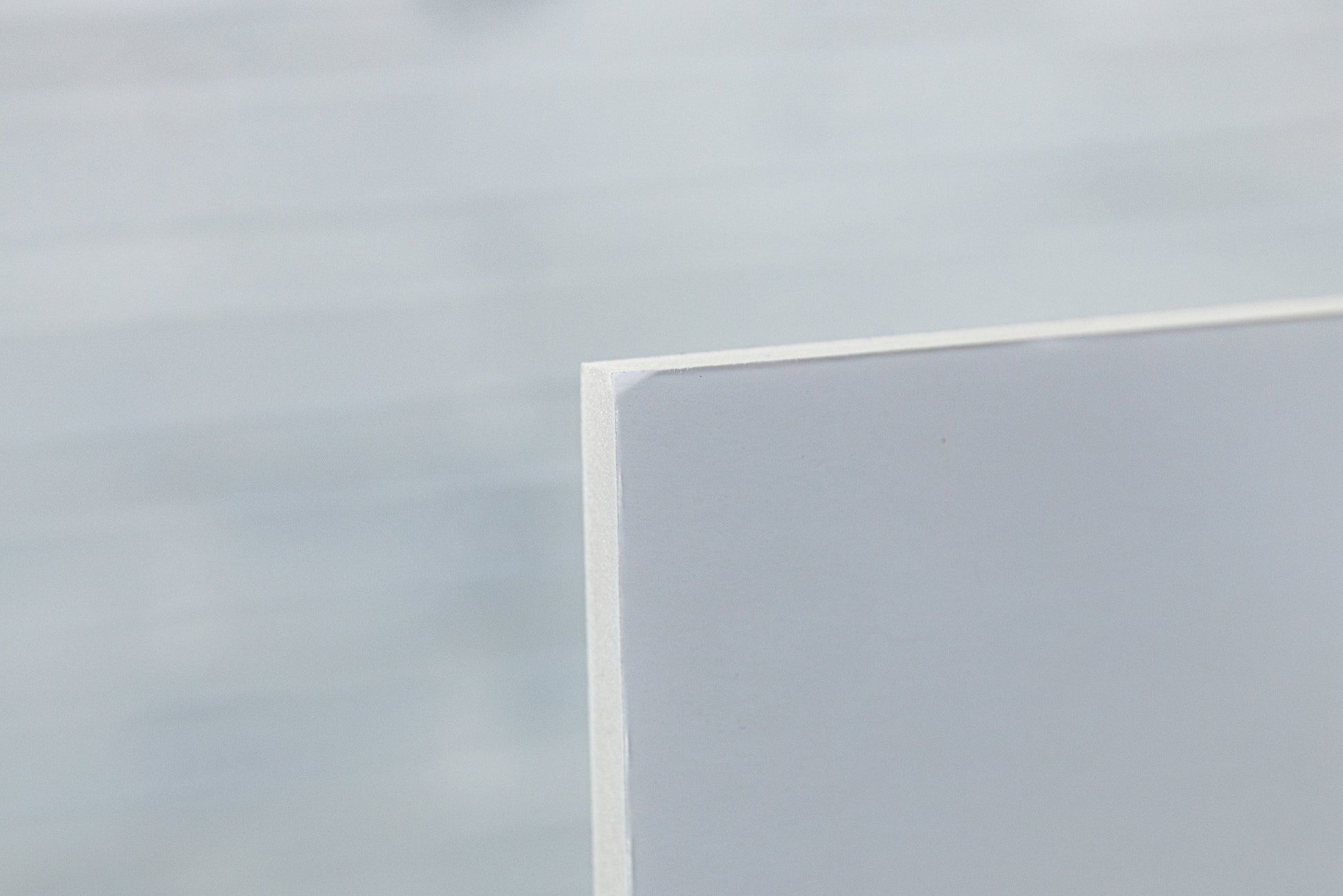 Close-up of rear foamboard corner showing a small scuff on the ex-display metallic photo print.