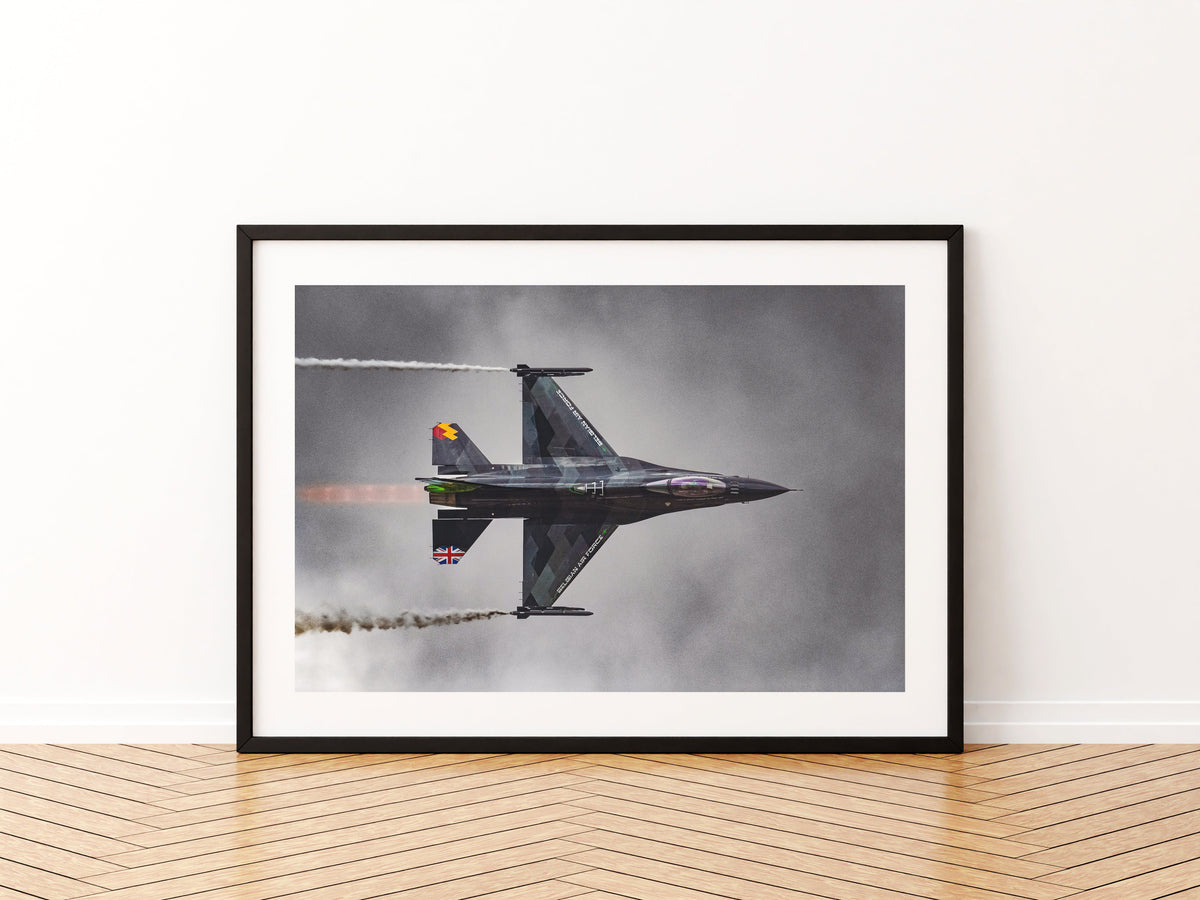 Belgian Air Force Dream Viper F-16 knife-edge pass with wingtip smoke under a dark sky, aviation photo wall art print in a black frame
