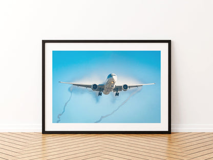 Qatar Airways Boeing 777 on approach in mist, twisting wingtip vortices trailing behind, aviation photo wall art print in a black frame