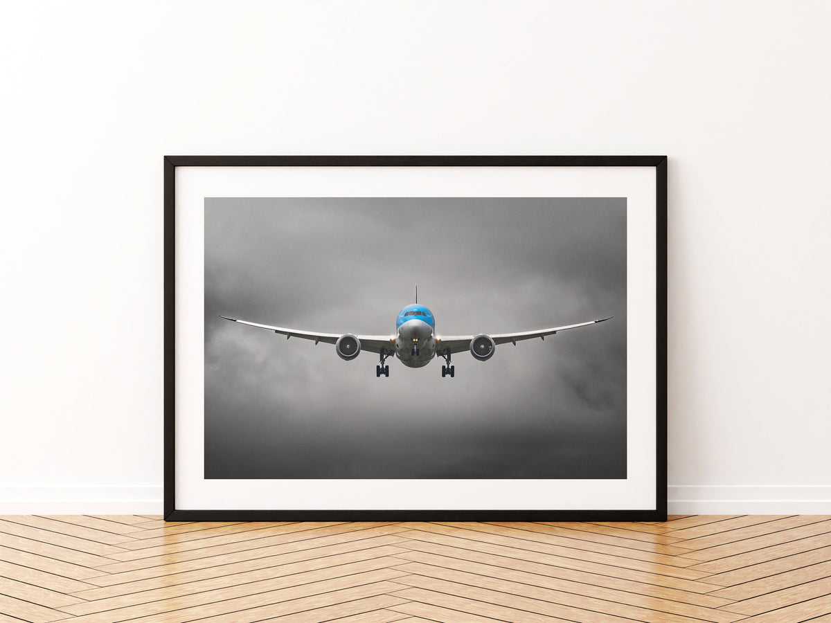 TUI Boeing 787 Dreamliner head-on on final approach, wings flexed, under dark grey cloud, aviation photo wall art print in a black frame