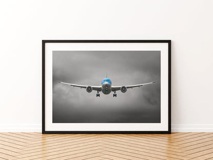 TUI Boeing 787 Dreamliner head-on on final approach, wings flexed, under dark grey cloud, aviation photo wall art print in a black frame