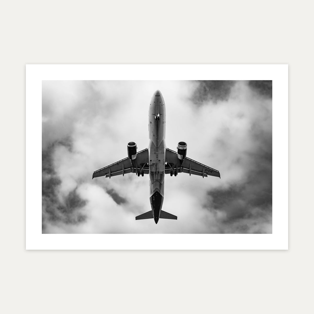 Airbus A320 passing directly overhead against bright cloud, black and white, unframed A4 aviation photo print