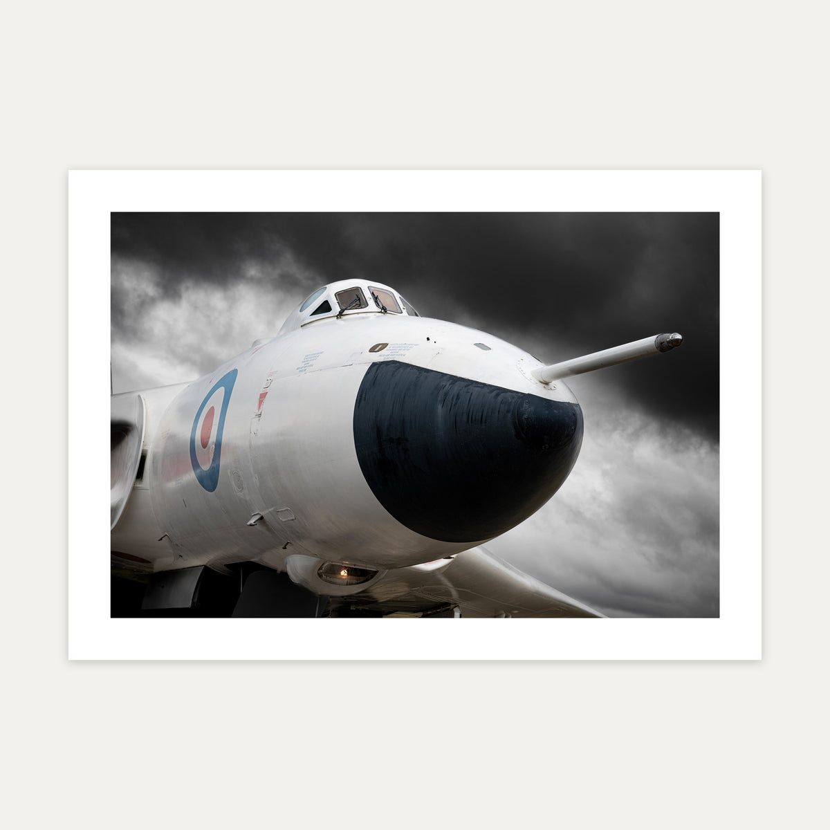Nose of an anti-flash white Avro Vulcan bomber under a dark stormy sky, unframed A4 aviation photo print