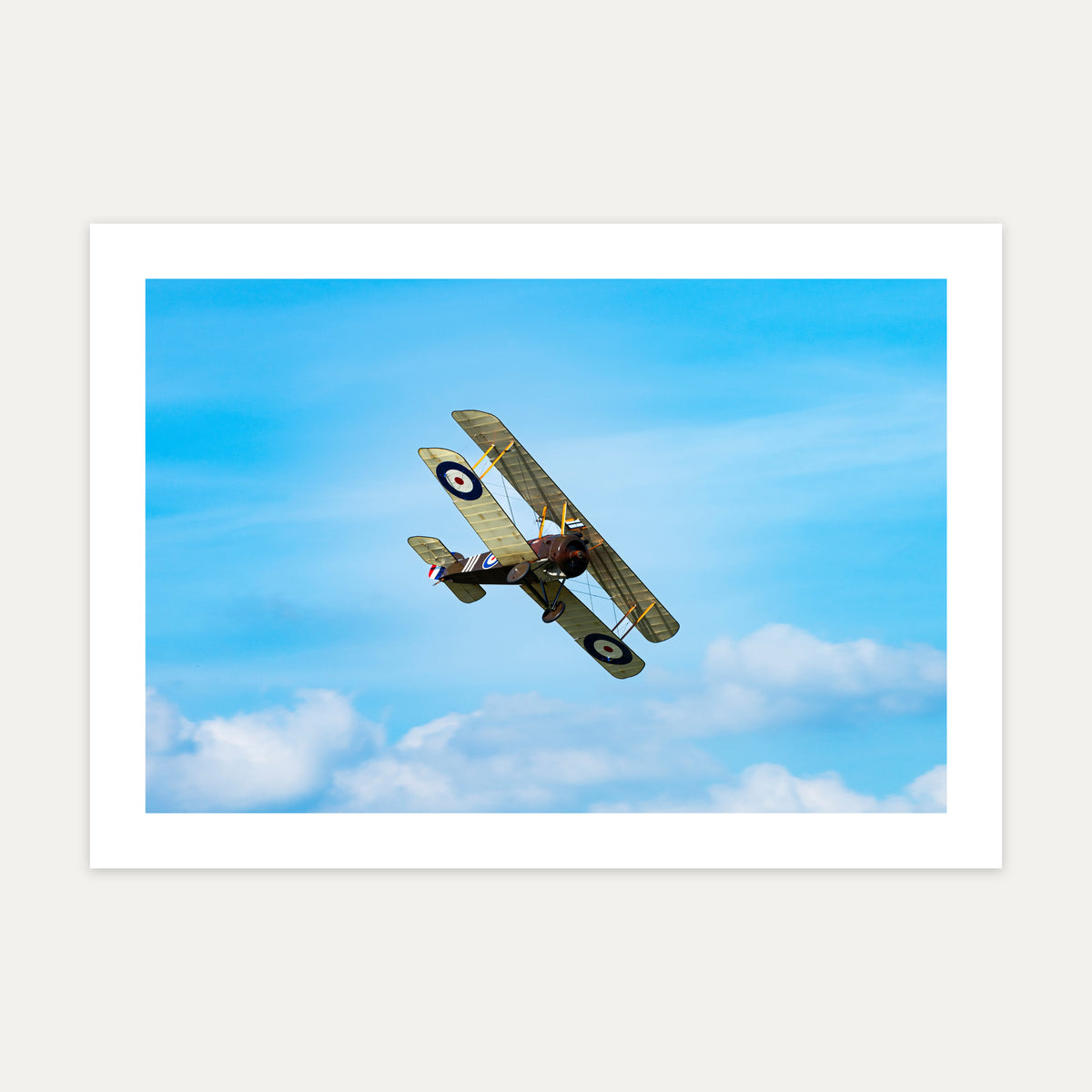 Sopwith Camel biplane climbing away against a blue sky with white cloud, unframed A4 aviation photo print