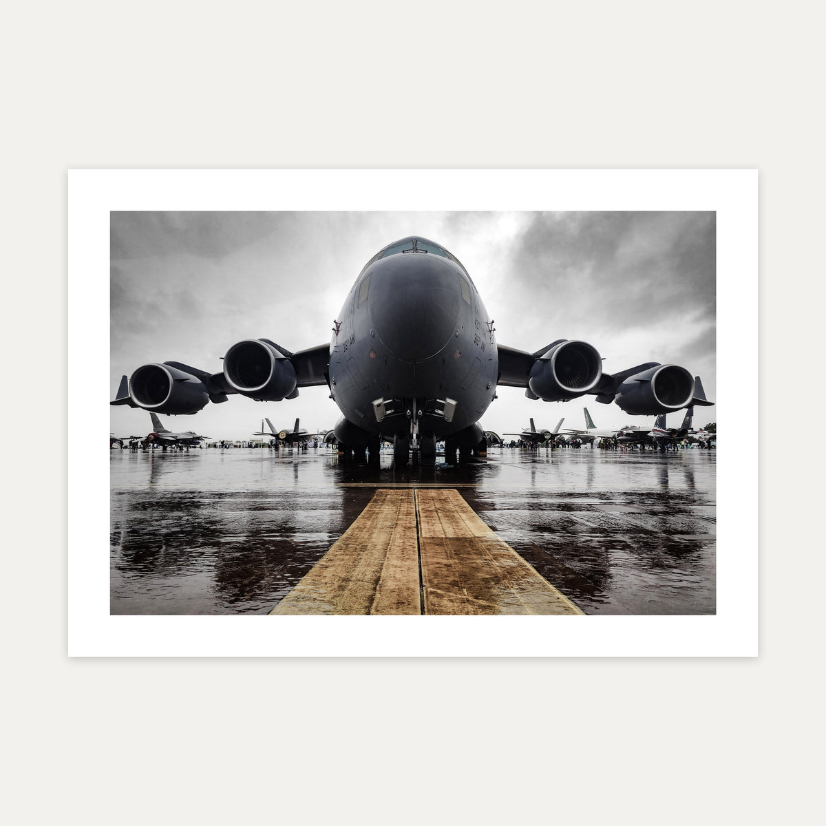 United States Air Force C-17 Globemaster III head-on on a rain-soaked static line under grey cloud, unframed A4 aviation photo print